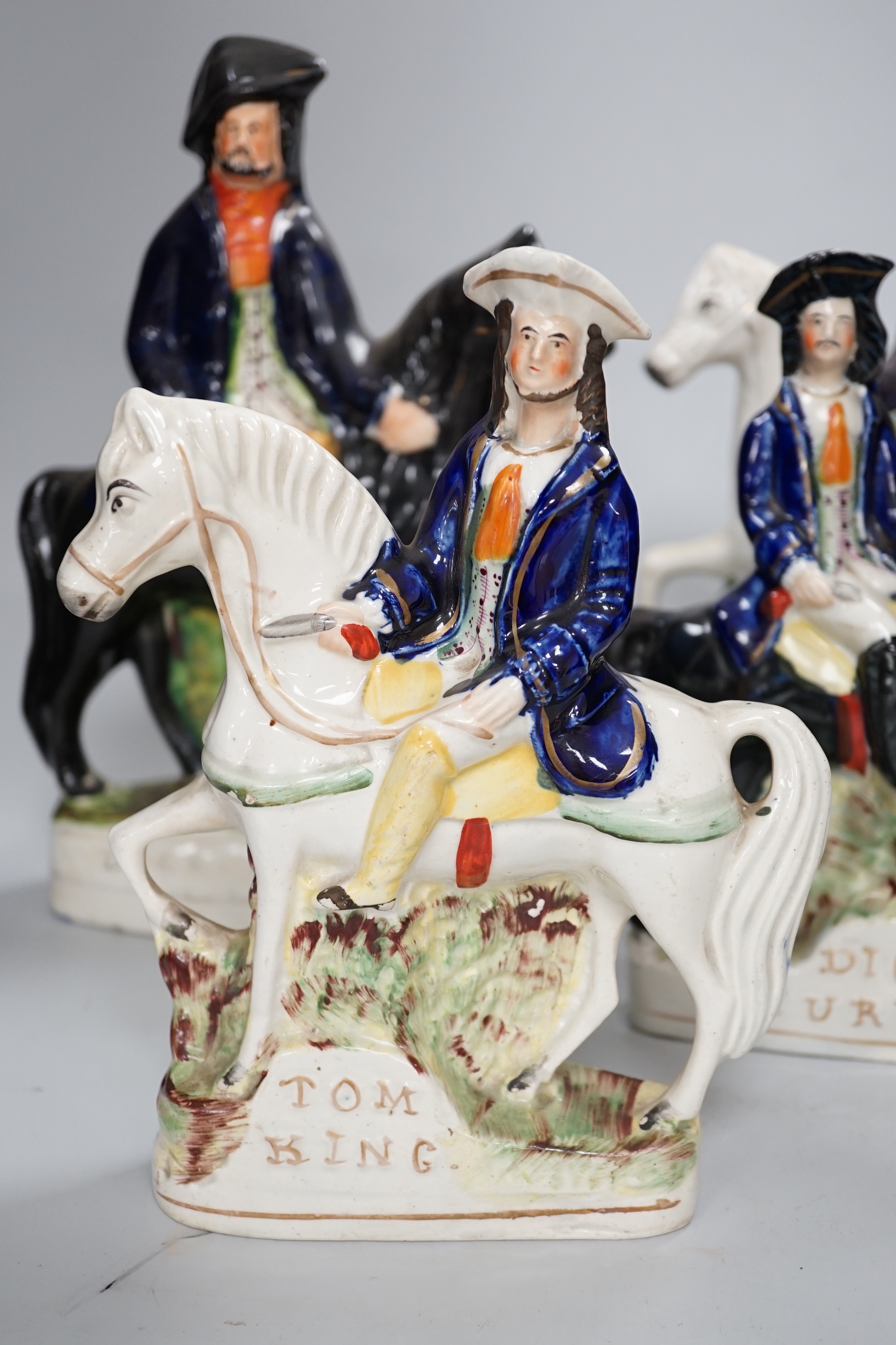 Two pairs of Staffordshire highwaymen figure groups of Tom King and Dick Turpin, the largest 30cm high